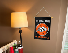 Load image into Gallery viewer, Oklahoma State basketball garden flag nging on a wall next to a lamp and drinks