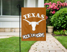 Load image into Gallery viewer, orange university of texas garden flag with hook em horns logo hung outside from garden flag stand
