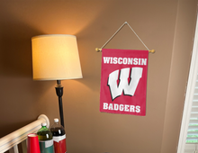 Load image into Gallery viewer, red university of wisconsin garden flag hanging on banner pole inside living room