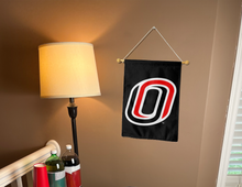 Load image into Gallery viewer, black UNO garden flag hanging on banner pole inside living room