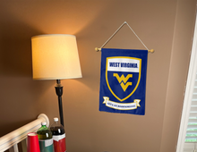 Load image into Gallery viewer, west virginia let's go mountaineers and shield logo garden flag hanging on banner pole next to lamp and drinks