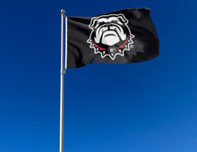 Load image into Gallery viewer, Black 3x5 foot wide university of georgia flag with bulldogs logo and two metal grommets attached to flagpole waving in the wind