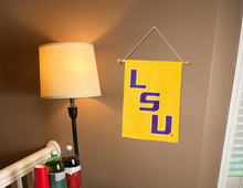 Load image into Gallery viewer, gold LSU Garden flag hanging on banner pole inside living room