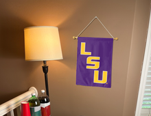 Load image into Gallery viewer, purple LSU Garden flag hanging on banner pole inside living room