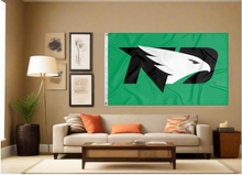 Load image into Gallery viewer, Green 3x5 University of North Dakota Flag with two metal grommets and black ND Logo covering tan wall of well lit room
