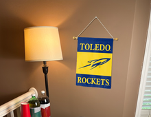 Load image into Gallery viewer, toledo university garden flag hanging on banner pole inside room