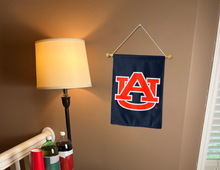 Load image into Gallery viewer, blue Auburn University garden flag hanging on banner pole inside room