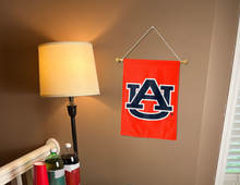 Load image into Gallery viewer, orange Auburn University garden flag hanging on banner pole inside room