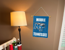 Load image into Gallery viewer, blue middle Tennessee State University garden flag hanging on banner pole inside living room