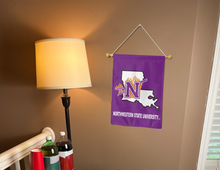 Load image into Gallery viewer, purple northwestern state university garden flag hanging on banner pole inside living room