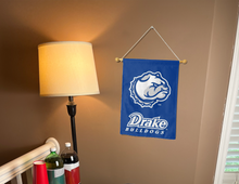 Load image into Gallery viewer, blue drake university garden flag hung from banner pole inside living room