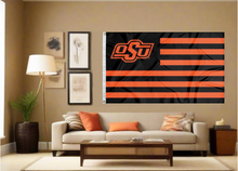 Load image into Gallery viewer, Oklahoma State University Flag with seven black stripes six orange stripes and two metal grommets for indoor home decor