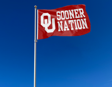Load image into Gallery viewer, red 3x5 feet University of Oklahoma Flag with OU Sooner Nation and two metal grommets for outdoor home decor attached to flagpole waving in the wind