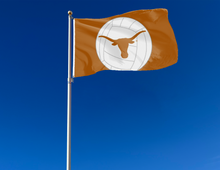 Load image into Gallery viewer, Orange University of Texas Volleyball Flag with two metal grommets attached to flagpole waving in the wind