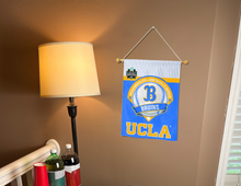 Load image into Gallery viewer, UCLA Baseball College World Series 2025 Garden flag hanging on banner pole inside living room