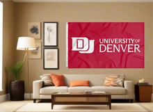 Load image into Gallery viewer, Red 3x5 foot wide University of Denver Flag with school logo and two metal grommets covering the tan wall of a living room