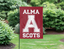 Load image into Gallery viewer, Maroon 13x18 inch long Alma College Garden Flag with Alma A College Scots Logo hanging on a black garden flag stand