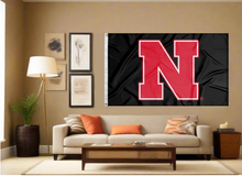 Load image into Gallery viewer, Black Nebraska Huskers Flag hung inside for man cave décor