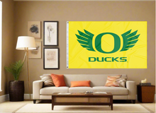 Load image into Gallery viewer, gold University of Oregon flag with Ducks logo hung inside the living room