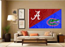 Load image into Gallery viewer, Red and Blue Alabama Florida House Divided Flag with two metal grommets covering tan wall of well lit room