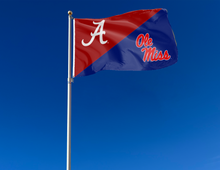 Load image into Gallery viewer, red and blue Alabama Ole Miss house divided flag attached to flagpole waving in the wind