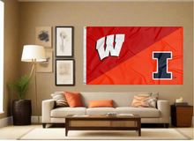 Load image into Gallery viewer, red and orange House Divided flag with Wisconsin Illinois Game logo and two metal grommets covering tan wall of living room