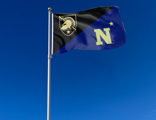 Load image into Gallery viewer, Black and blue Army West Point Naval Academy House Divided Flag with two metal grommets attached to flagpole waving in the wind
