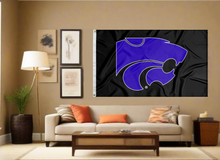 Load image into Gallery viewer, Black 3x5 foot wide Kansas State University Wildcats Flag with two metal grommets covering the tan wall of a well-lit room