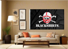 Load image into Gallery viewer, Black Nebraska Huskers flag with original blackshirts logo displayed inside a well-lit room