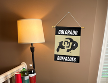 Load image into Gallery viewer, black and gold colorado buffaloes garden flag hung inside college dorm