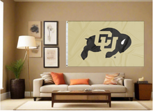 Load image into Gallery viewer, Gold 3x5 feet wide University of Colorado Buffaloes Flag covering the tan wall inside of a well organized room with couch pillows and light