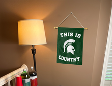 Load image into Gallery viewer, This is Michigan State Spartans Country garden flag hung inside a dorm