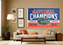 Load image into Gallery viewer, blue white and orange Florida Basketball March Madness Three Time Champions 3x5 Flag with two metal grommets covering tan wall of well lit room