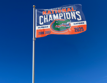 Load image into Gallery viewer, blue white and orange Florida Basketball March Madness Three Time Champions 3x5 Flag with two metal grommets attached to flagpole waving in the wind
