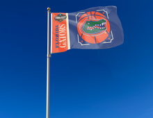 Load image into Gallery viewer, Orange and blue Florida Basketball Men's Final Four Flag with two metal grommets attached to a flagpole waving in the wind
