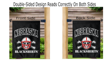 Load image into Gallery viewer, black university of nebraska garden flag with nebraska blackshirts logo hung from mailbox flagpole displayed from both sides