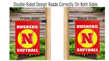 Load image into Gallery viewer, outdoor display of Nebraska Softball garden flag from both sides
