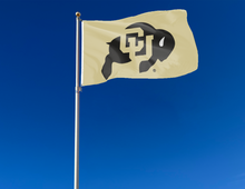 Load image into Gallery viewer, Gold 3x5 feet wide University of Colorado Buffaloes Flag attached to flagpole waving in the wind