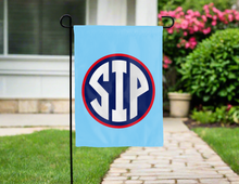 Load image into Gallery viewer, blue double sided garden flag with ole miss sip logo hung outside for yard decor