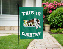 Load image into Gallery viewer, green double sided garden flag with this is Siena University country logo for yard decor