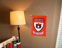 Load image into Gallery viewer, auburn garden flag with shield and war eagle logos hung inside a college dorm for dorm decor