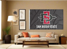 Load image into Gallery viewer, indoor display of black san diego state aztecs flag for fan cave decor
