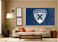 Load image into Gallery viewer, indoor display of blue xavier university flag with shield logo for man cave decor