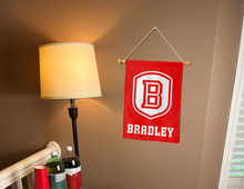 Load image into Gallery viewer, bradley university garden flag hung inside a college dorm for dorm decor