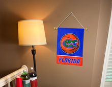 Load image into Gallery viewer, florida basketball garden flag hung inside a college dorm for college dorm decor