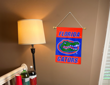 Load image into Gallery viewer, orange and blue florida gators double sided garden flag hung inside a college dorm for dorm decor