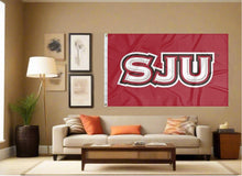 Load image into Gallery viewer, indoor display of red saint joseph's university flag with sju hawks logo for man cave decor