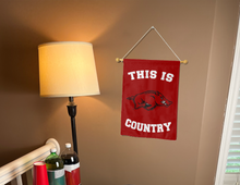 Load image into Gallery viewer, this is arkansas country garden flag hung inside a college dorm for dorm decor