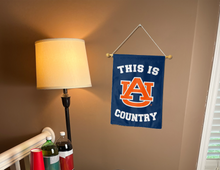 Load image into Gallery viewer, this is auburn country garden flag hung indoors for college dorm decor