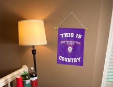 Load image into Gallery viewer, this is northwestern state country garden flag hung inside a college dorm for dorm decor